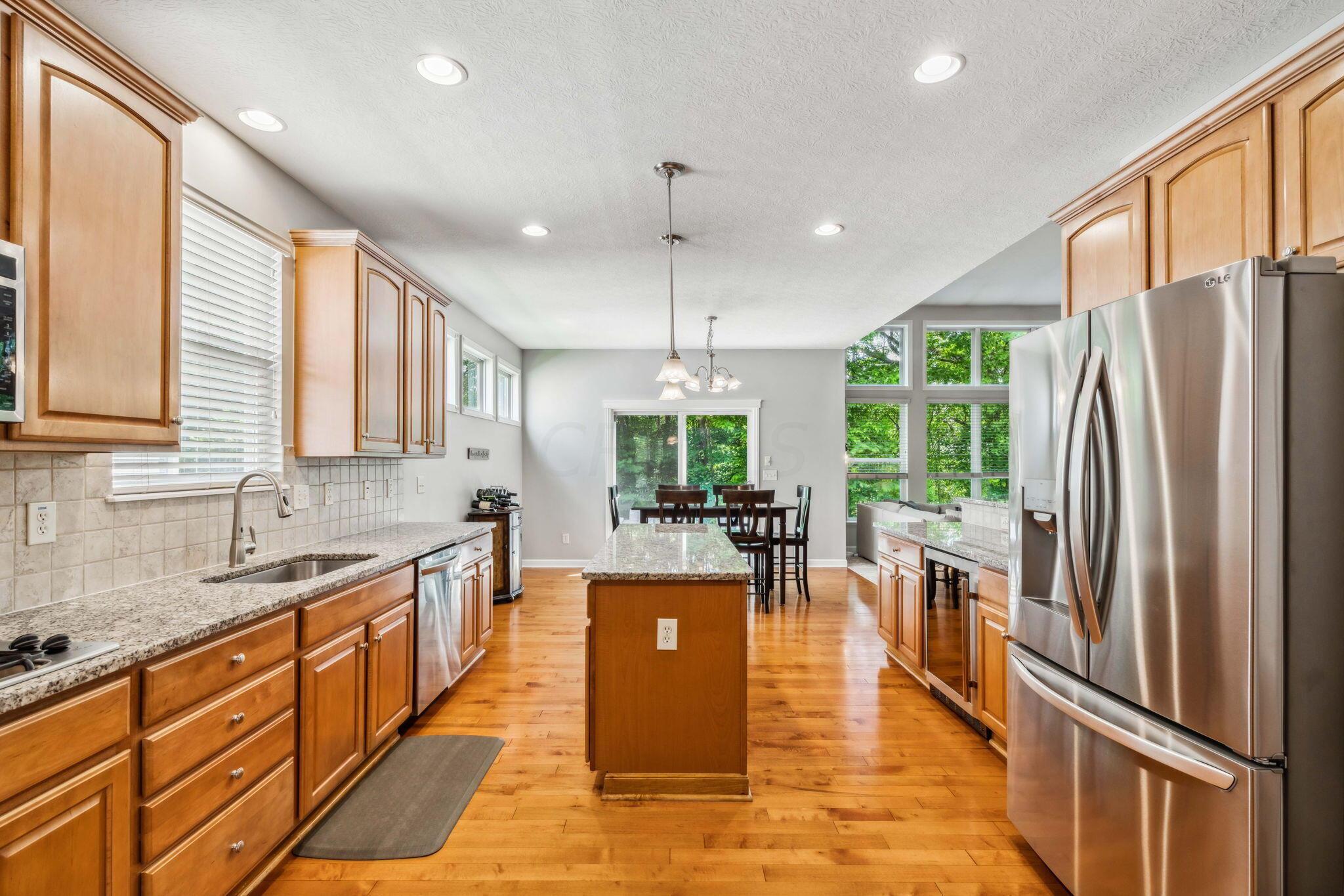 219 Smokewood Road Powell, OH 43065 - Photo 12 of 59 Granite countertops, island, walk-in pantry, single basin sink, gas top range, double wall ovens and built-in wine fridge!