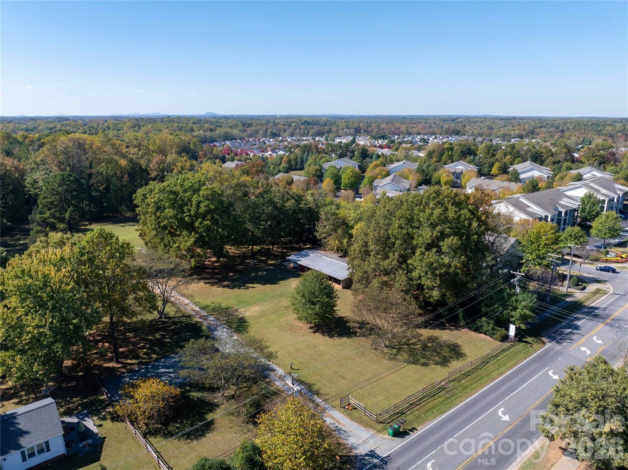 9009 Reames Road Charlotte, NC 28216 - Photo 4 of 6 an aerial view of a residential houses with outdoor space and trees in the background
