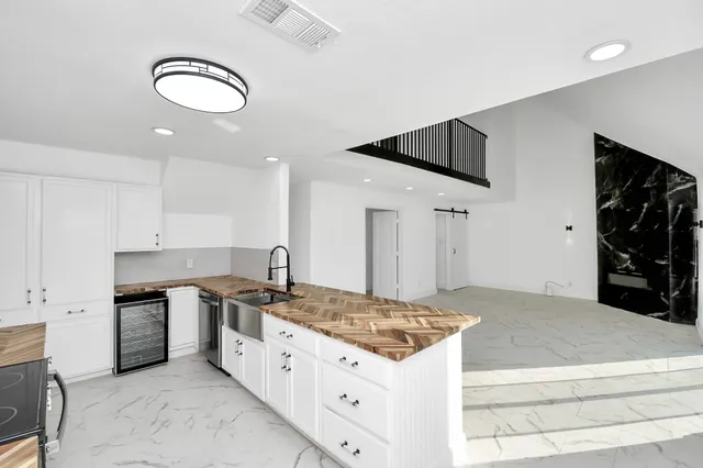 a kitchen with stainless steel appliances granite countertop a stove and a refrigerator