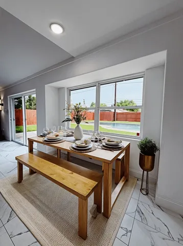 a kitchen with a stove and a view of living room