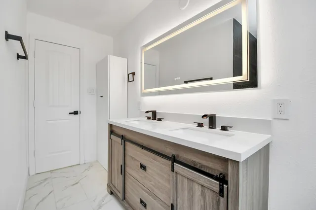 a bathroom with a sink and a mirror