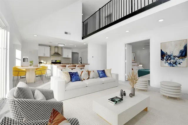 a living room with furniture and kitchen view