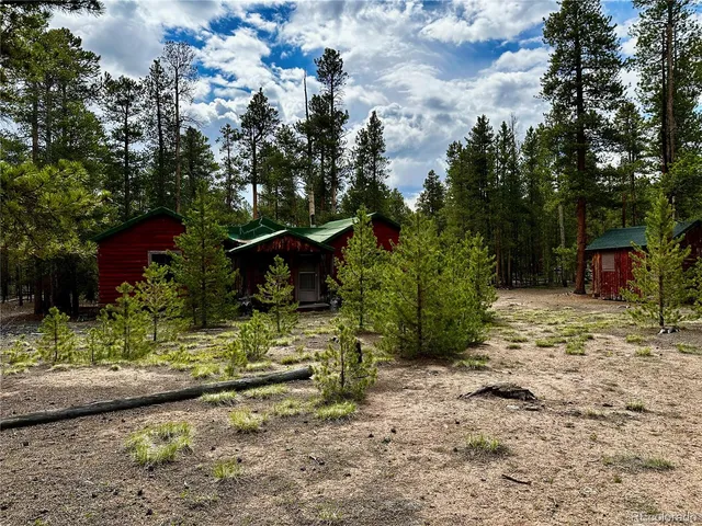 a view of a wooden house with a yard