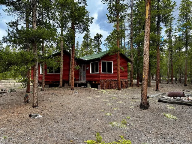 a view of a house with a tree in the yard