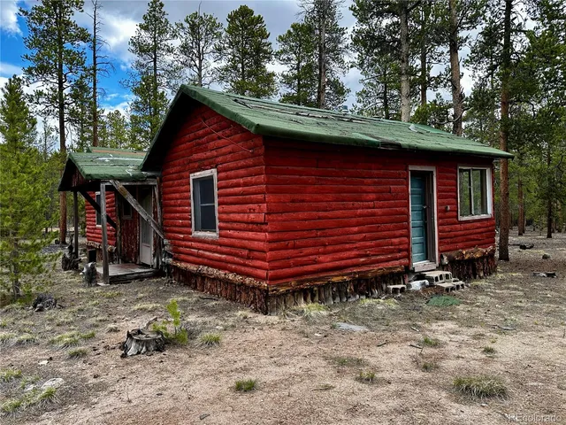 a backyard of a house with barbeque oven and table
