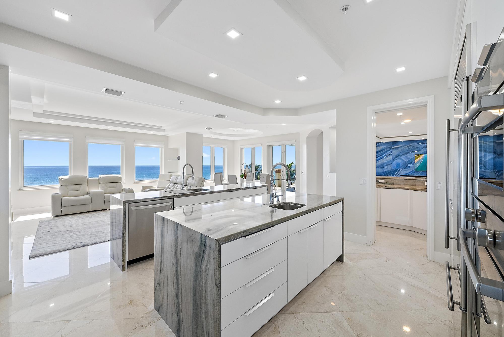 2070 North Ocean Boulevard, Unit PH4 Boca Raton, FL 33431 - Photo 13 of 46 a kitchen with stainless steel appliances granite countertop a sink and stove