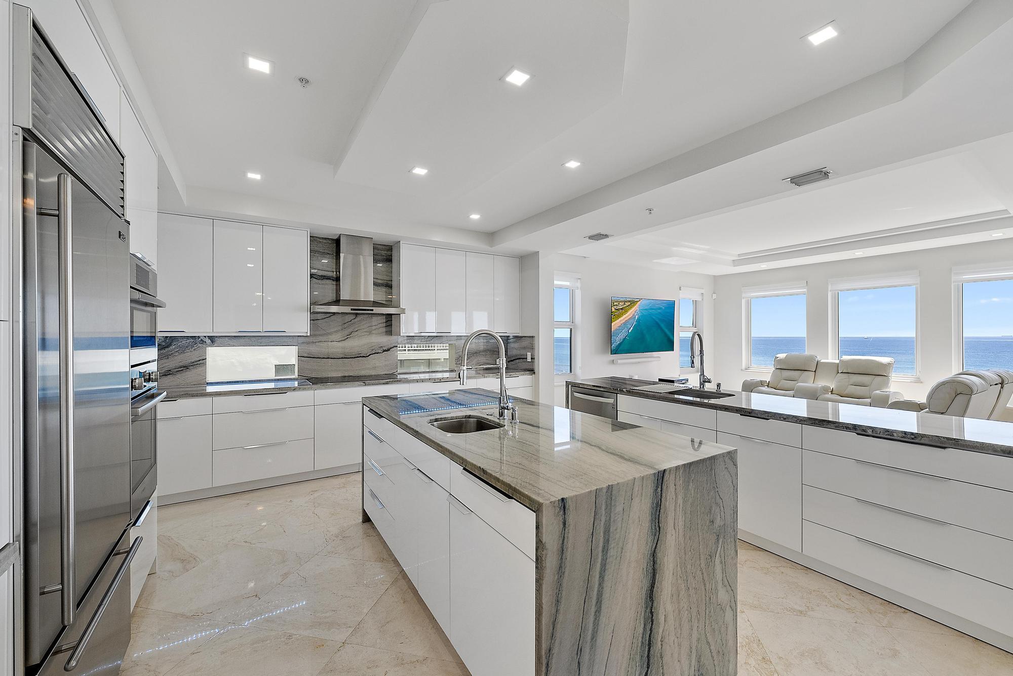 2070 North Ocean Boulevard, Unit PH4 Boca Raton, FL 33431 - Photo 14 of 46 a kitchen with a sink stainless steel appliances and cabinets