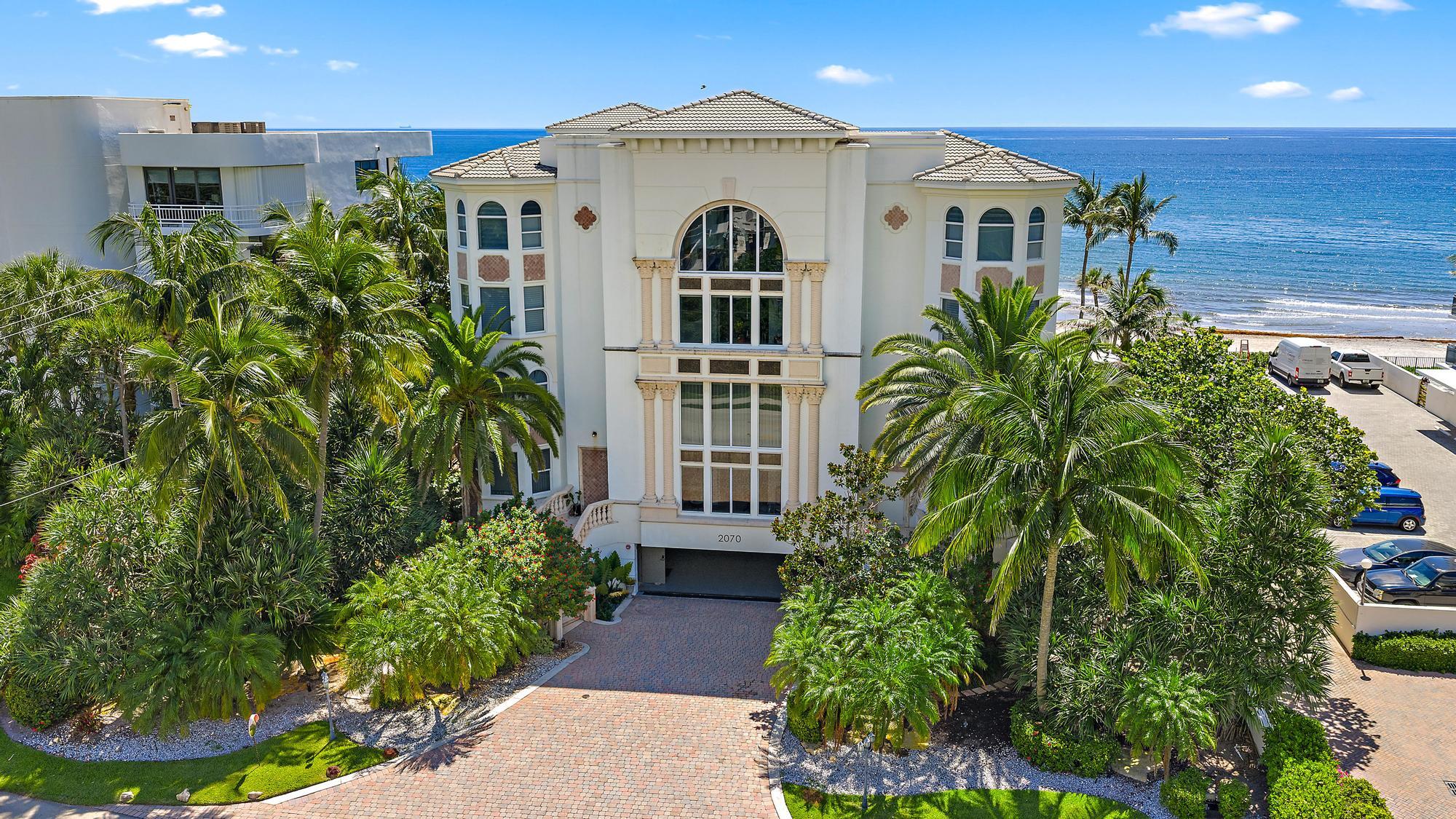 2070 North Ocean Boulevard, Unit PH4 Boca Raton, FL 33431 - Photo 2 of 46 a front view of a house with a yard