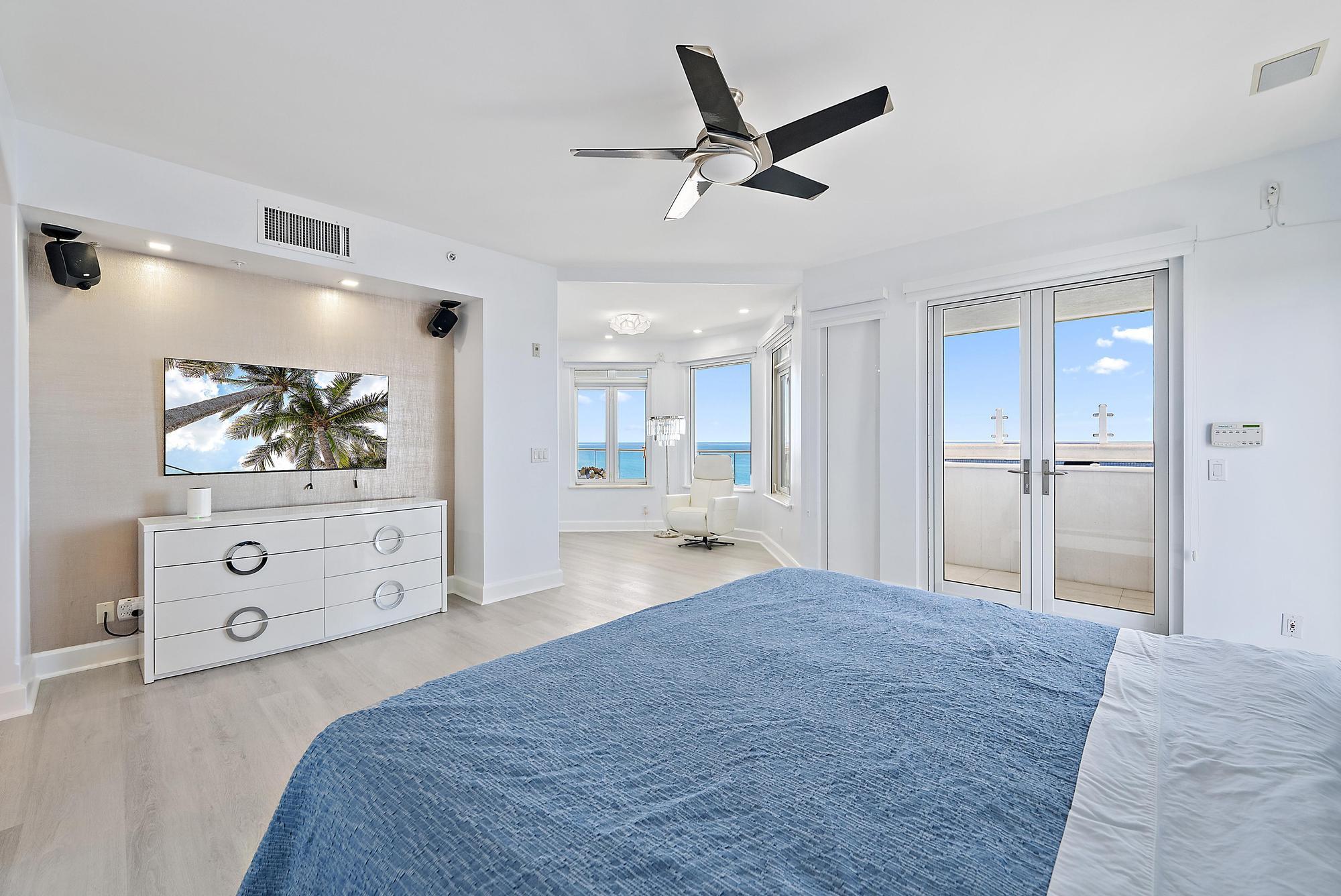 2070 North Ocean Boulevard, Unit PH4 Boca Raton, FL 33431 - Photo 23 of 46 a bedroom with a bed and a painting on the wall