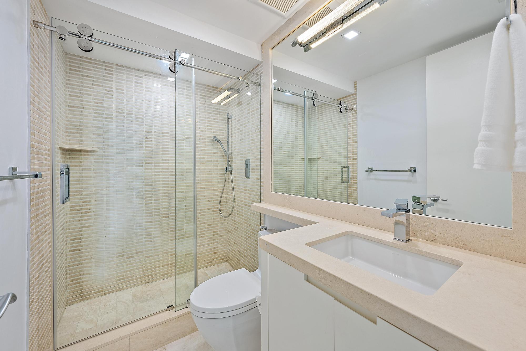 2070 North Ocean Boulevard, Unit PH4 Boca Raton, FL 33431 - Photo 33 of 46 a bathroom with a sink toilet and shower