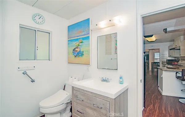a bathroom with a sink a toilet and mirror