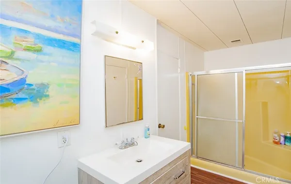 a bathroom with a sink a mirror and a shower