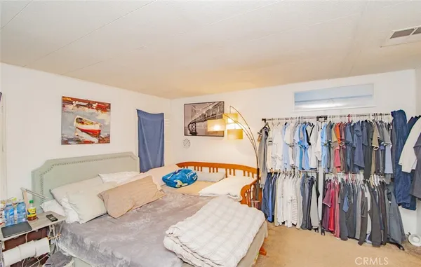a bedroom with a bed and a walk in closet