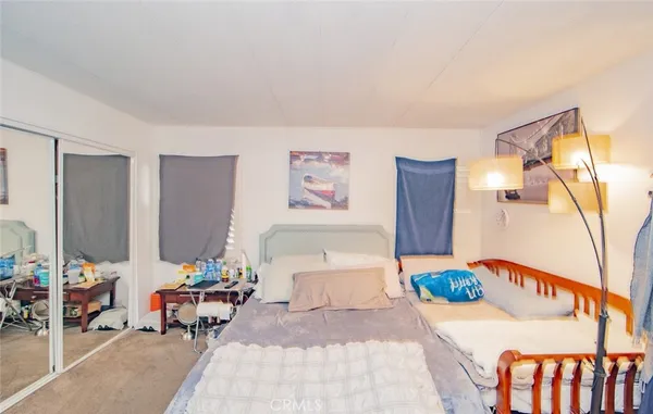 a bedroom with furniture and a potted plant