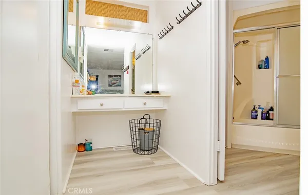 a view of a hallway with a dining table and a mirror