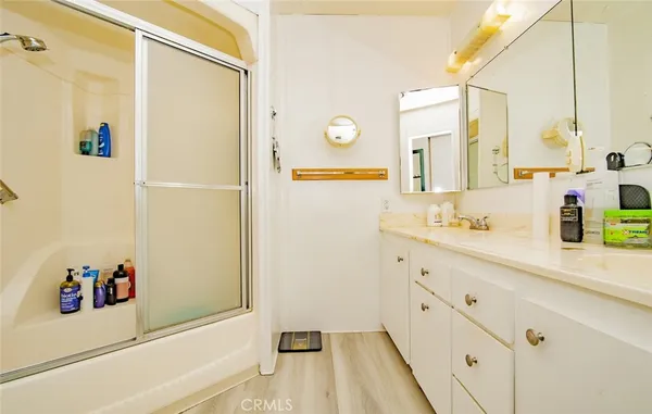a bathroom with a double vanity sink and a mirror