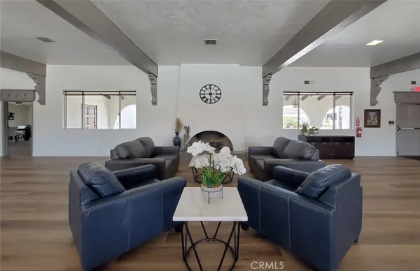 a living room with furniture fireplace and window