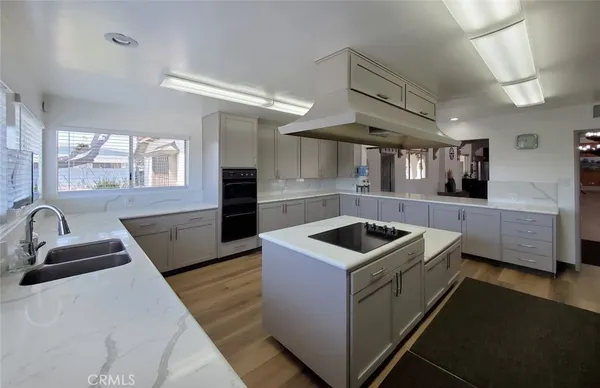 a kitchen that has a sink and a stove in it
