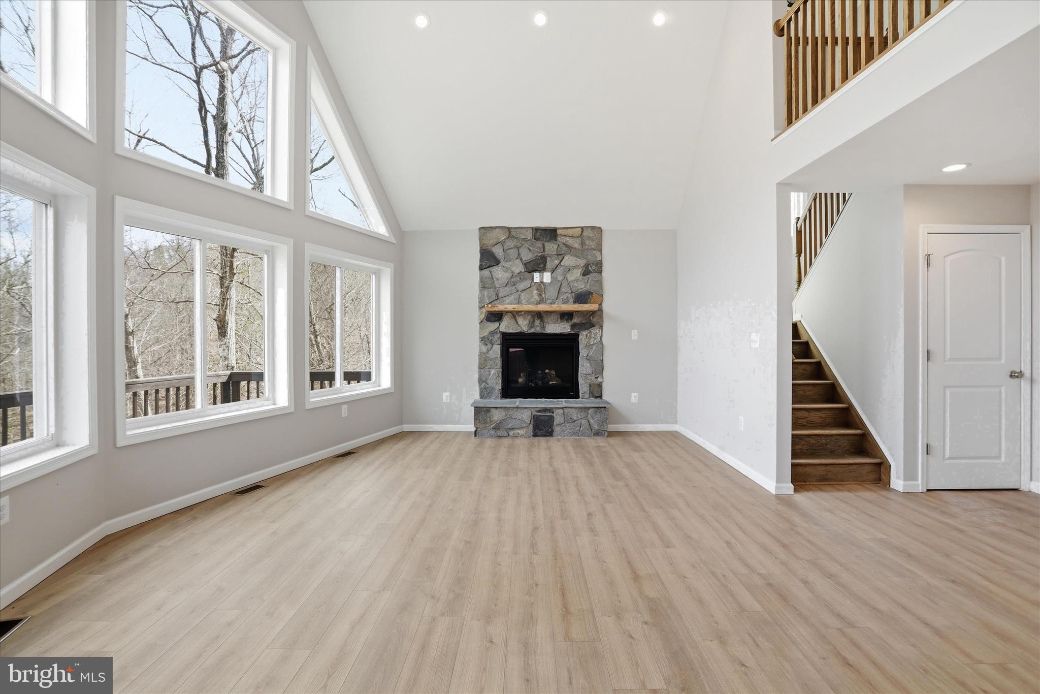 490 Black Twig Road Linden, VA 22642 - Photo 12 of 44 a view of an empty room with wooden floor fireplace and a window