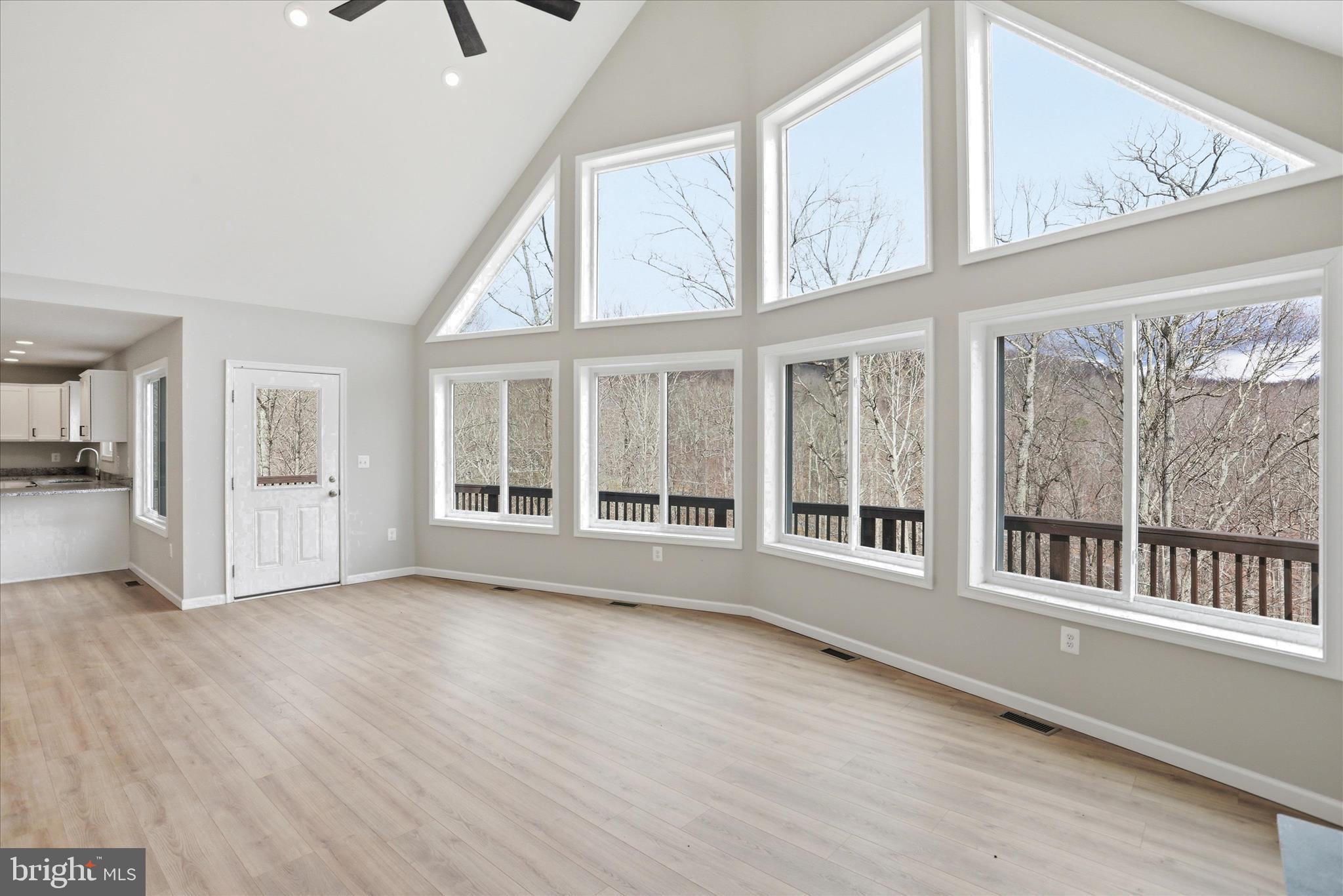 490 Black Twig Road Linden, VA 22642 - Photo 13 of 44 an empty room with wooden floor and windows