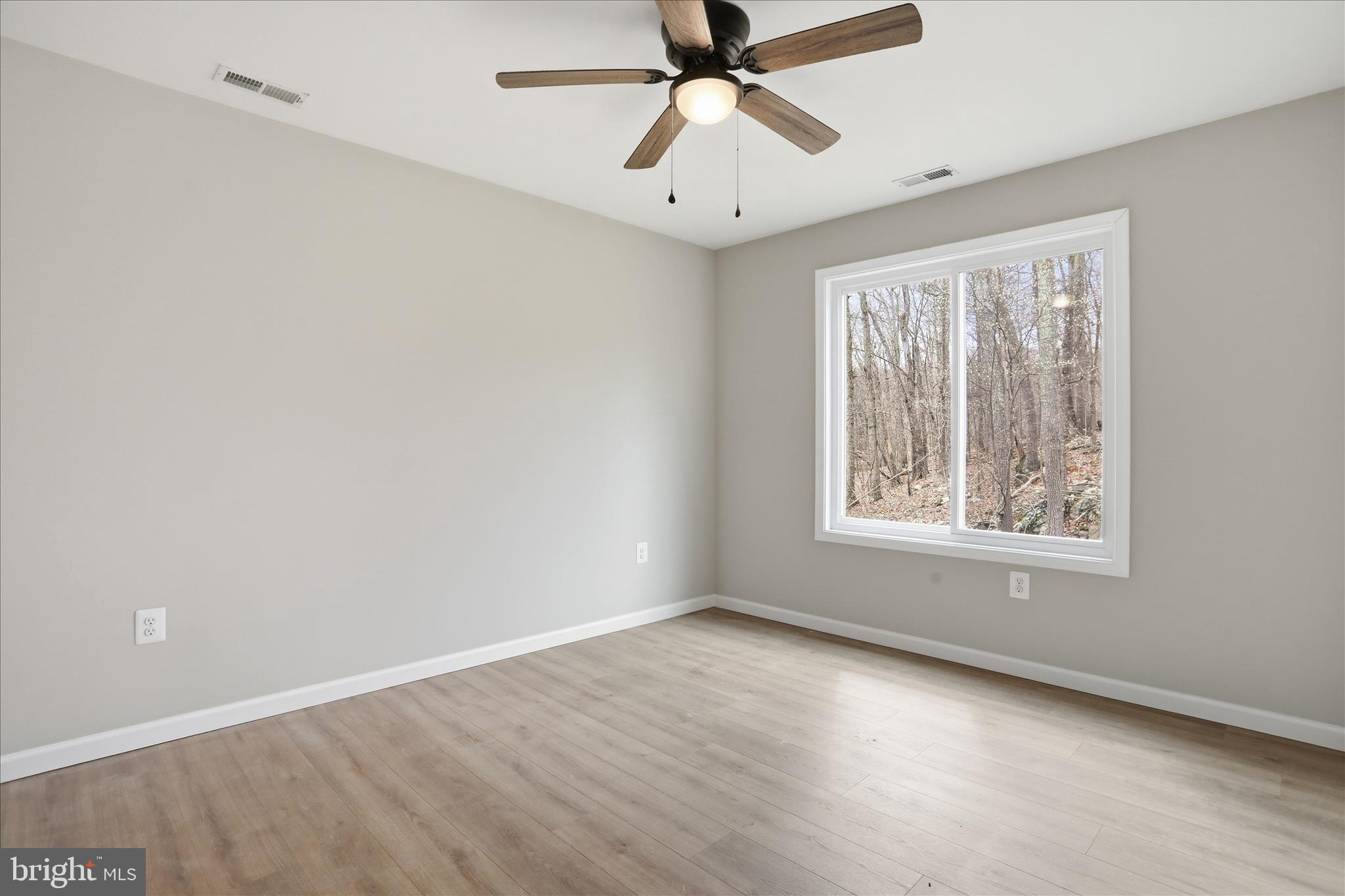 490 Black Twig Road Linden, VA 22642 - Photo 23 of 44 a view of an empty room with wooden floor and a window