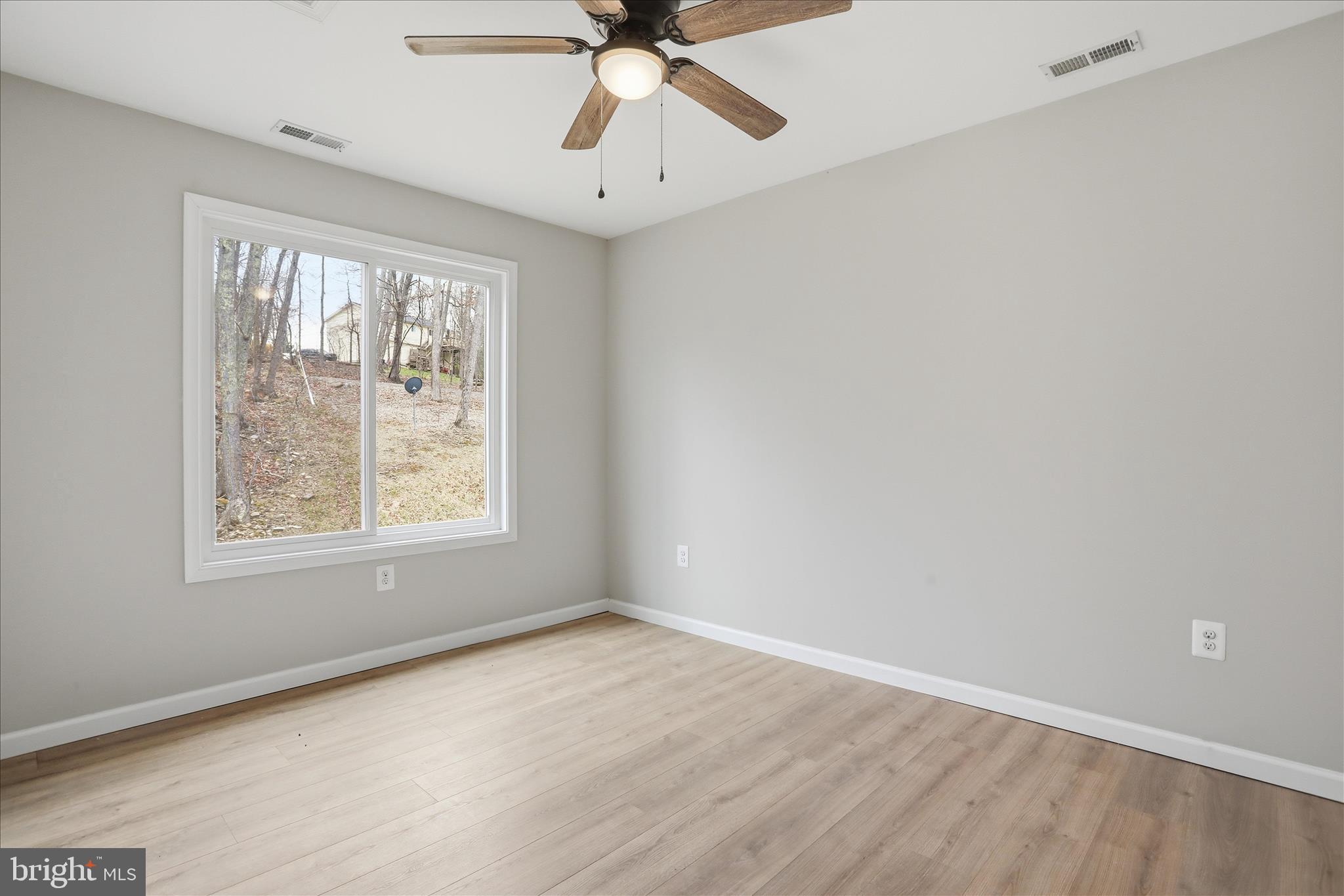 490 Black Twig Road Linden, VA 22642 - Photo 26 of 44 an empty room with a window and a fan