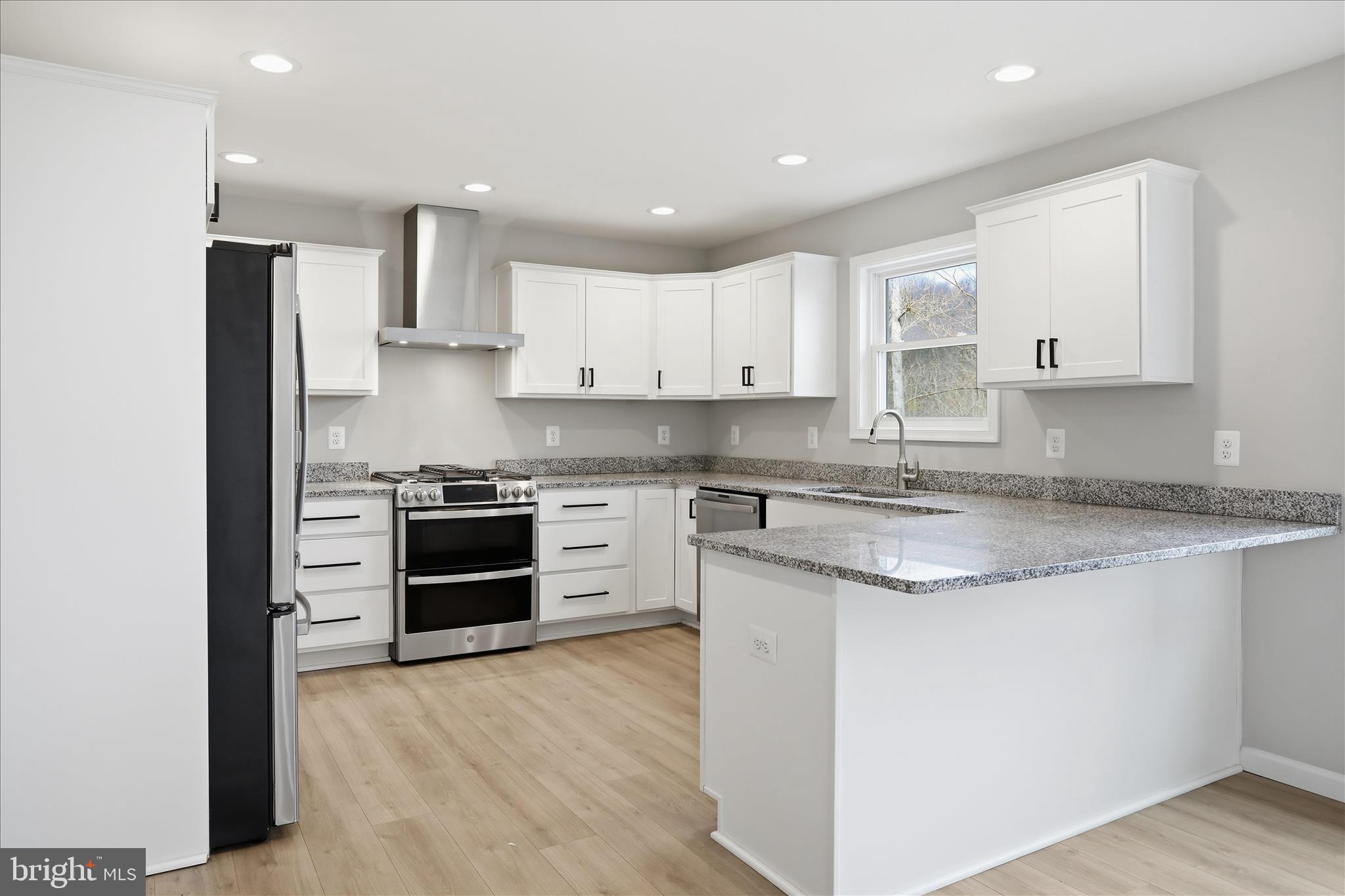 490 Black Twig Road Linden, VA 22642 - Photo 4 of 44 a kitchen with stainless steel appliances granite countertop a stove top oven a sink and white cabinets