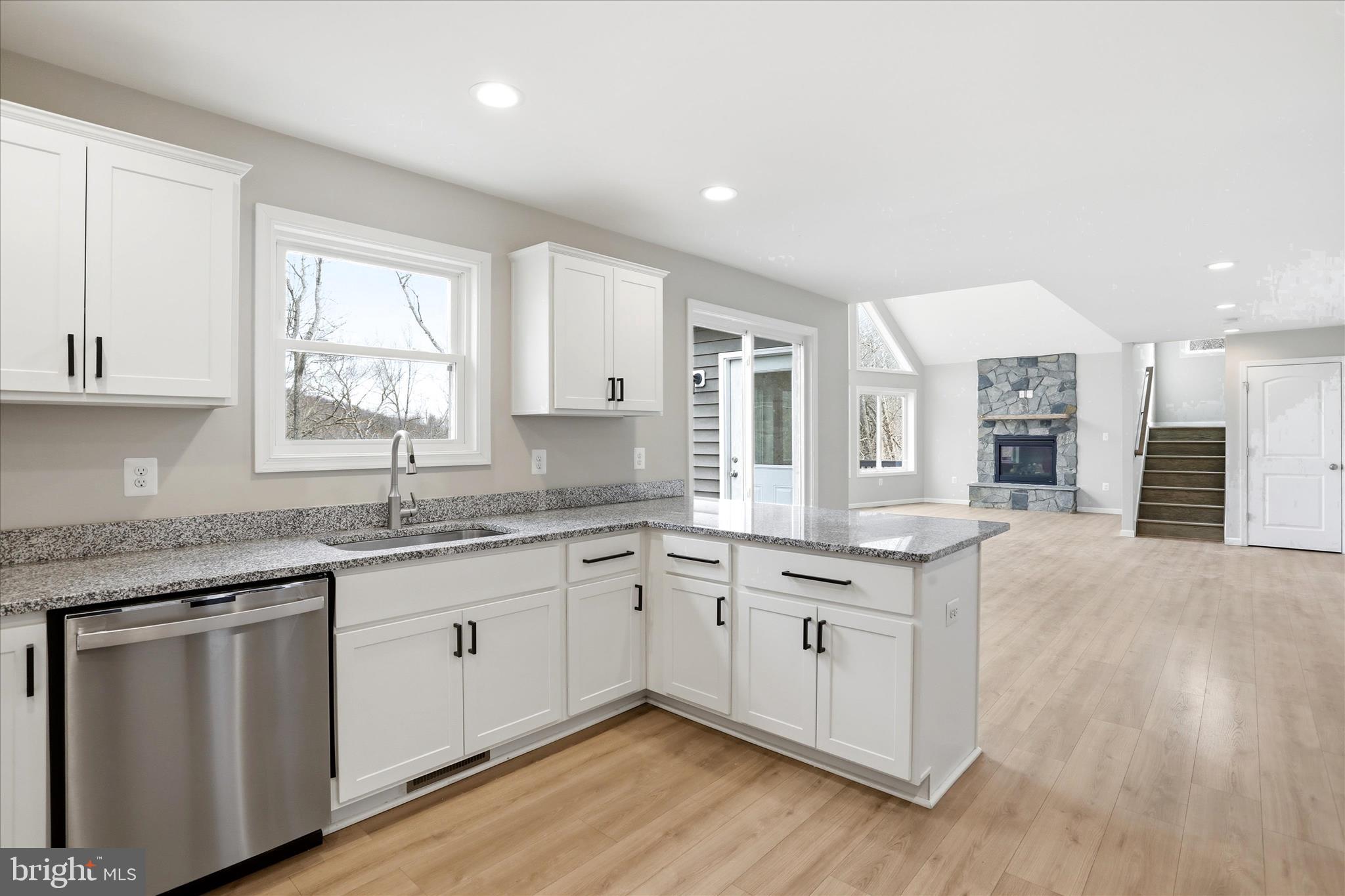 490 Black Twig Road Linden, VA 22642 - Photo 5 of 44 a kitchen with granite countertop a sink stove and cabinets