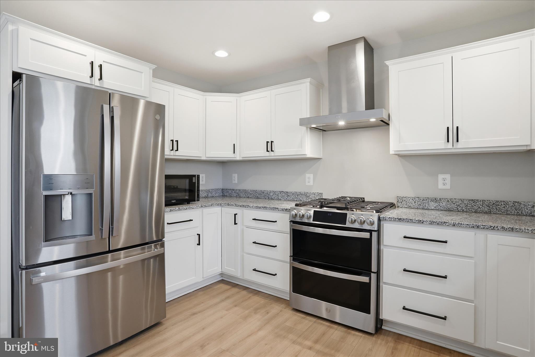490 Black Twig Road Linden, VA 22642 - Photo 7 of 44 a kitchen with stainless steel appliances granite countertop a refrigerator stove and white cabinets