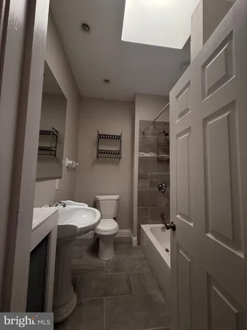 a bathroom with a toilet a sink and shower