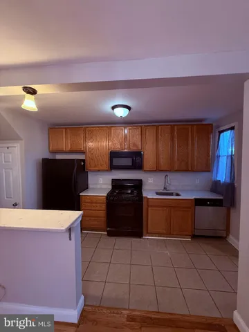 a kitchen with stainless steel appliances a stove a sink and a microwave