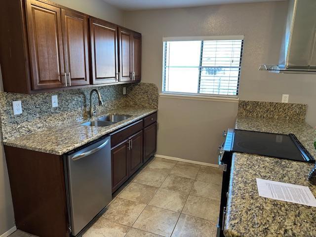 5500 Ragan Drive The Colony, TX 75056 - Photo 7 of 17 Kitchen featuring tasteful backsplash, black electric range oven, a sink, dishwasher, and baseboards