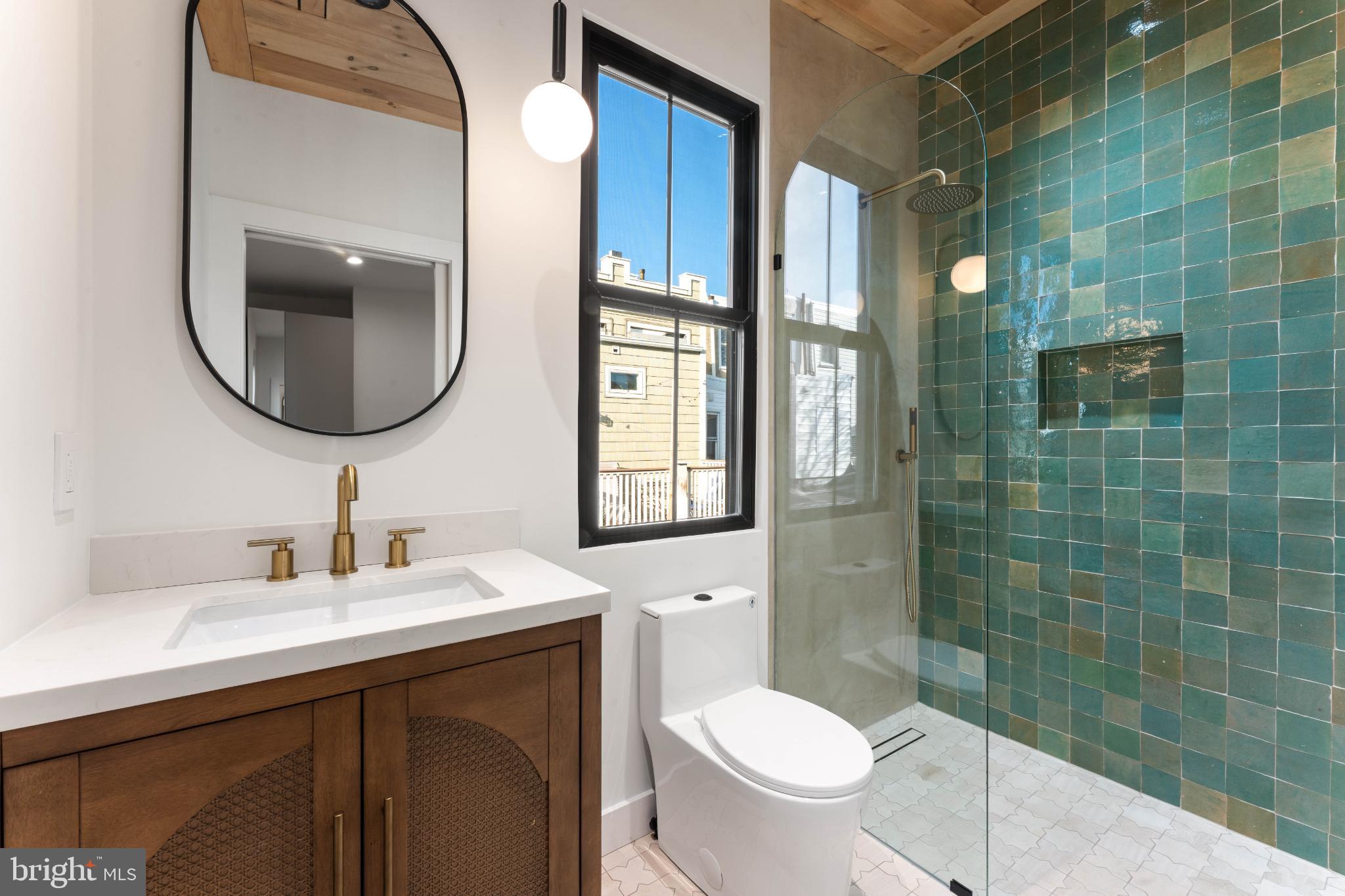 823 Mercer Street Philadelphia, PA 19125 - Photo 34 of 37 a bathroom with a toilet sink and mirror