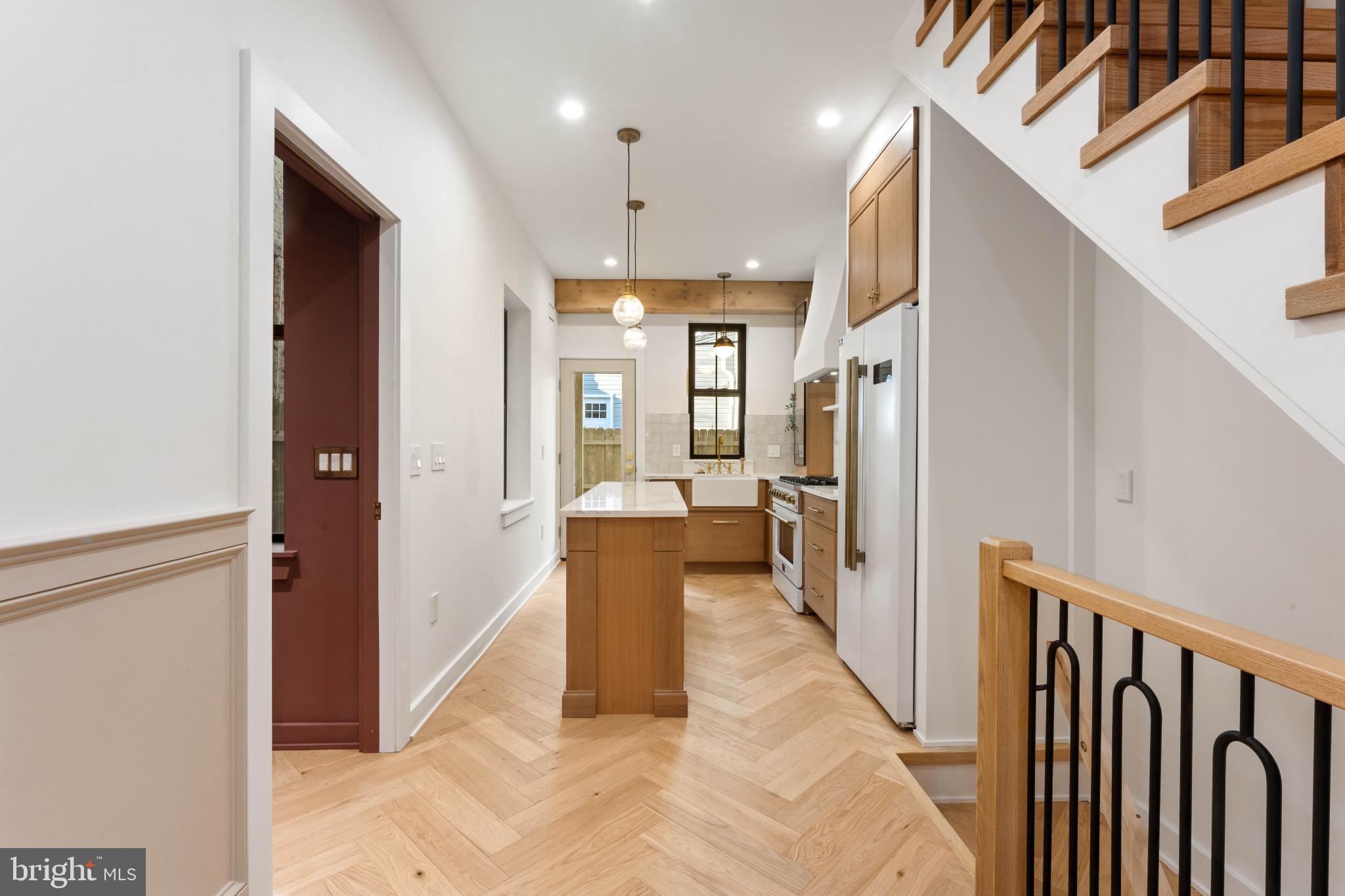 823 Mercer Street Philadelphia, PA 19125 - Photo 8 of 37 a view of a hallway with wooden floor and staircase