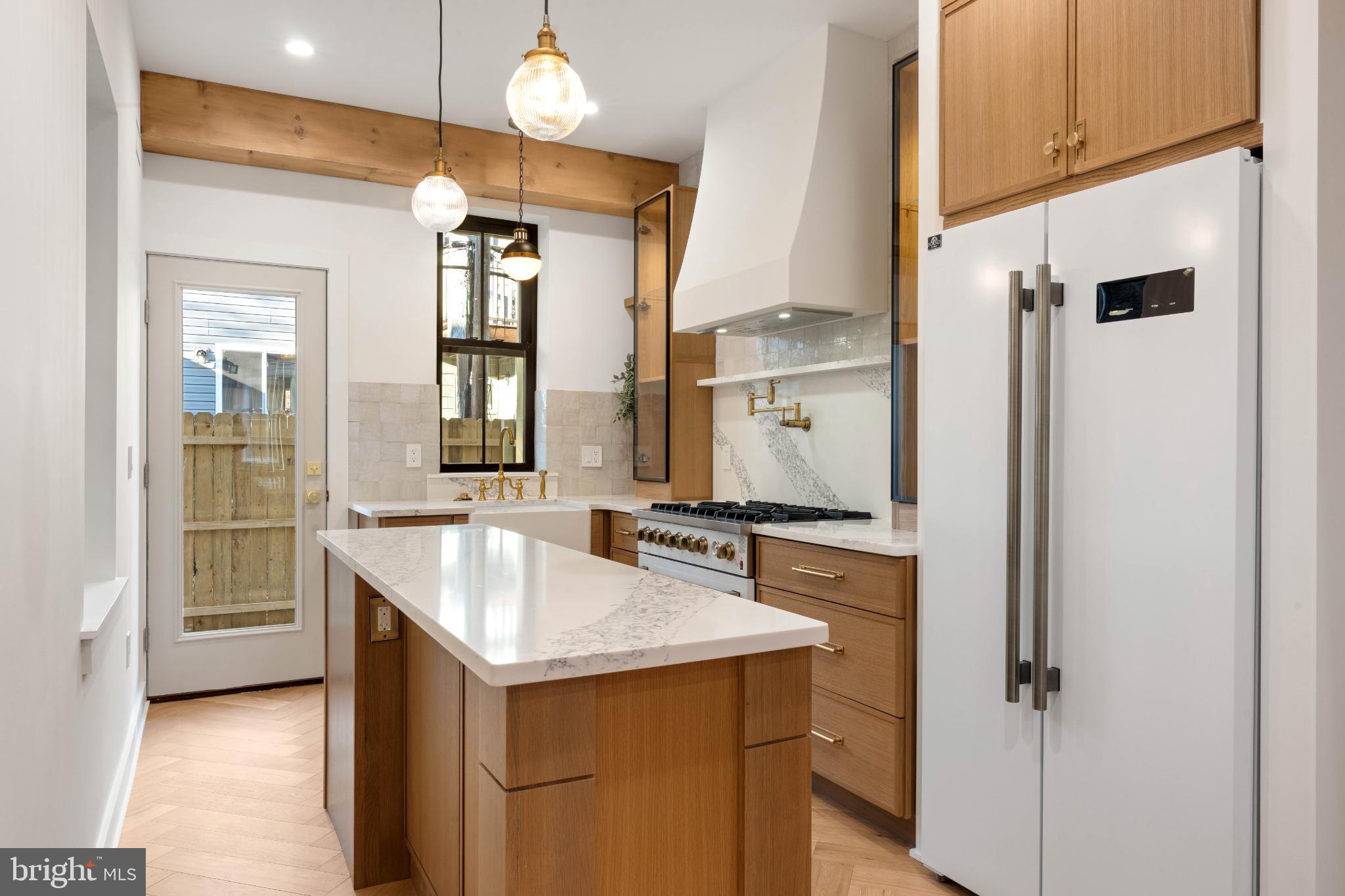 823 Mercer Street Philadelphia, PA 19125 - Photo 10 of 37 a kitchen with a sink cabinets appliances and a window