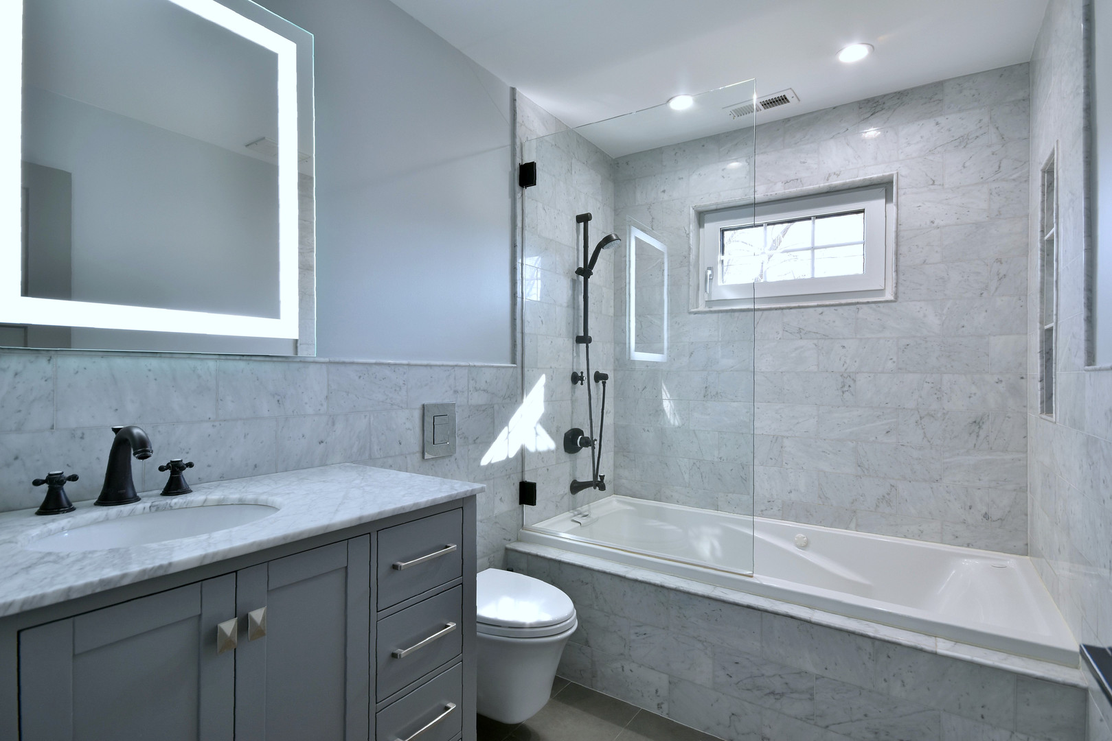 1237 Huber Lane Glenview, IL 60025 - Photo 23 of 49 a bathroom with a granite countertop sink a toilet and bathtub