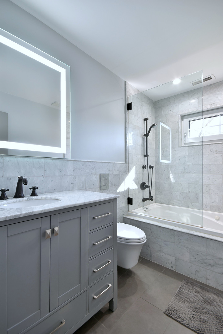 1237 Huber Lane Glenview, IL 60025 - Photo 24 of 49 a bathroom with a double vanity sink a toilet and bathtub