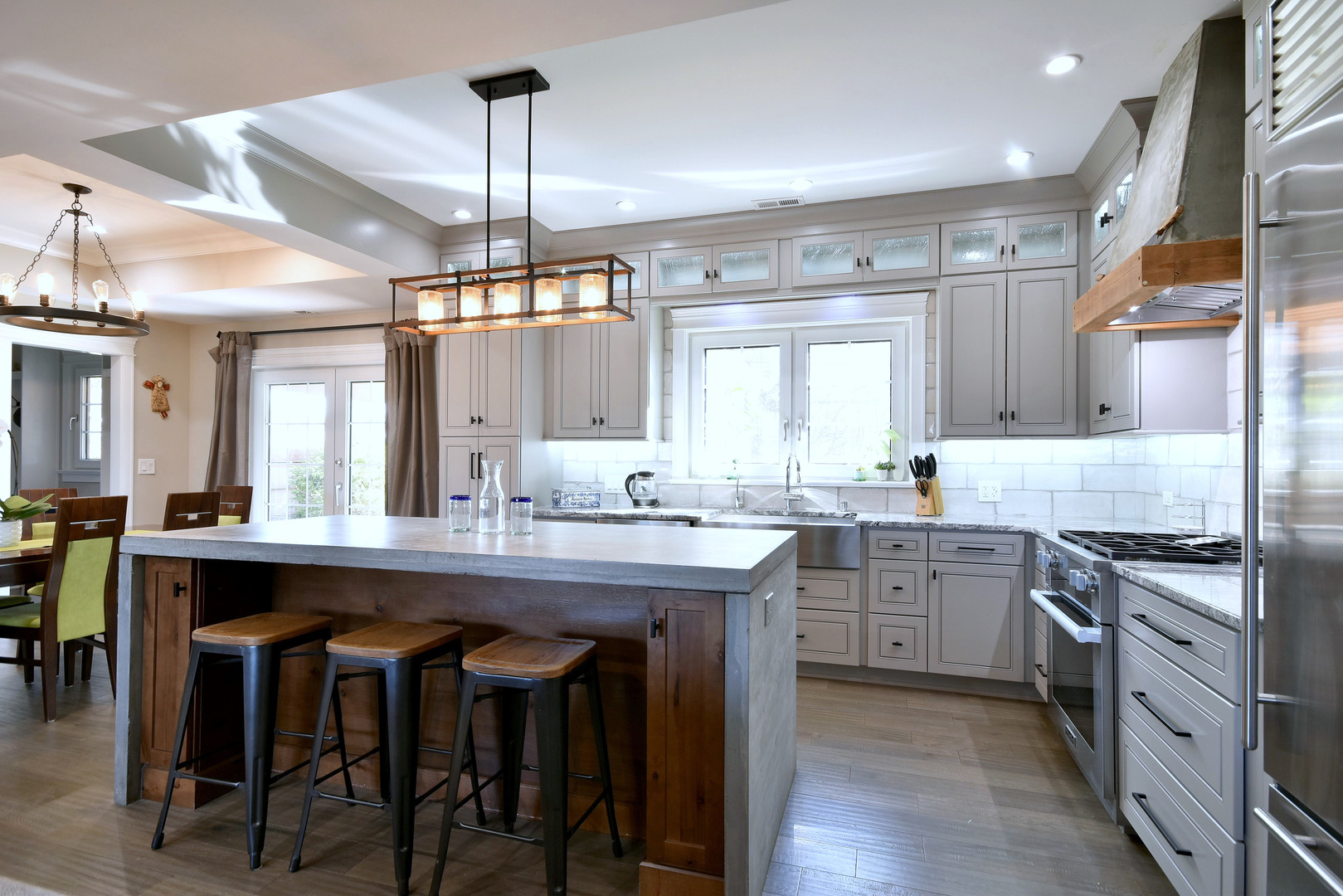 1237 Huber Lane Glenview, IL 60025 - Photo 4 of 49 a kitchen with kitchen island granite countertop a sink a stove and chairs