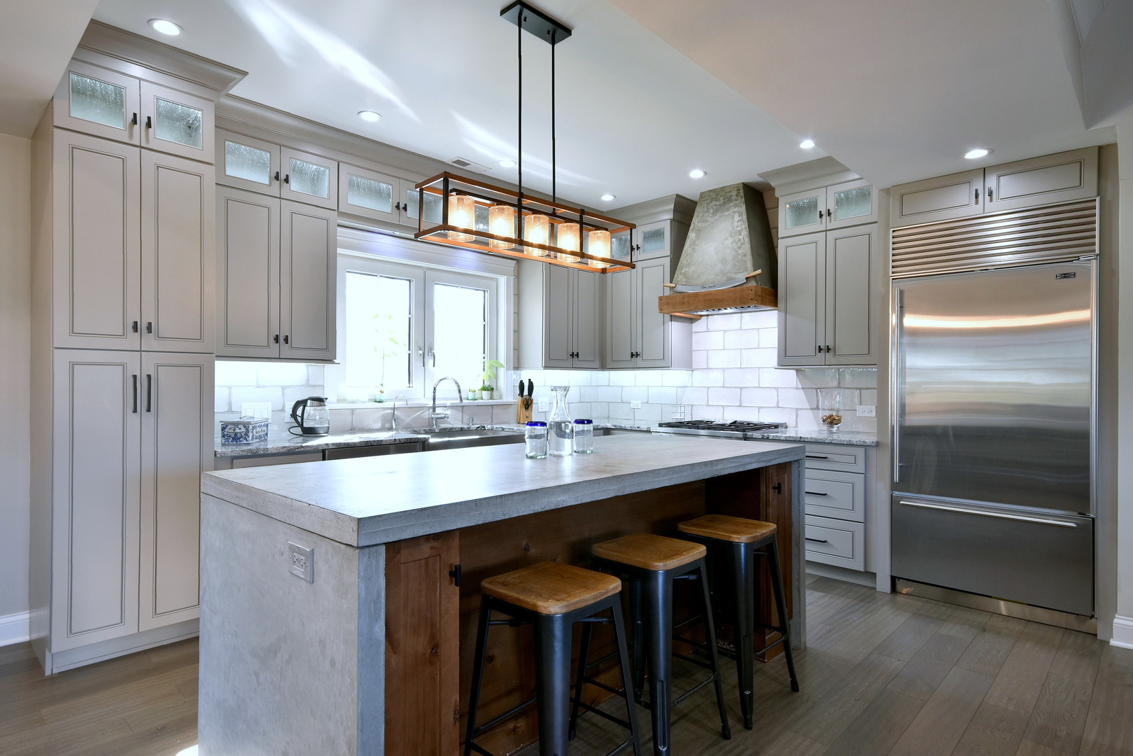 1237 Huber Lane Glenview, IL 60025 - Photo 5 of 49 a kitchen with kitchen island granite countertop a sink and refrigerator