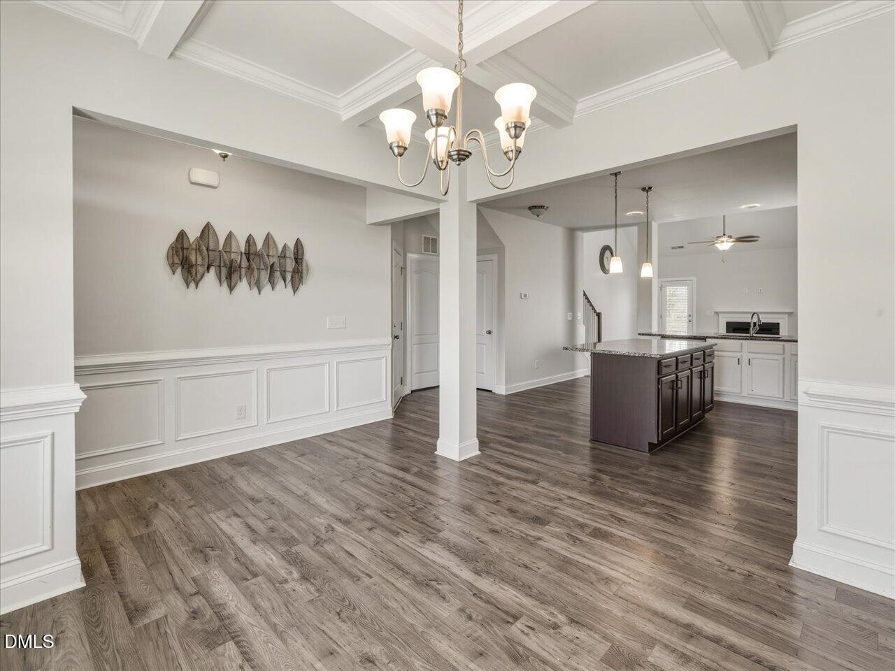 60 Pepper Lane Garner, NC 27529 - Photo 10 of 70 a view of a hallway with wooden floor and a chandelier