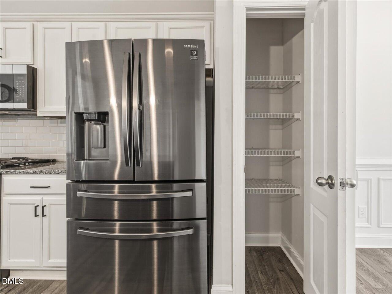 60 Pepper Lane Garner, NC 27529 - Photo 19 of 70 a metallic refrigerator freezer sitting in a kitchen