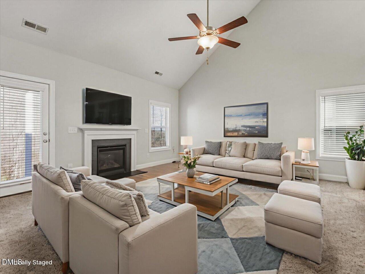 60 Pepper Lane Garner, NC 27529 - Photo 23 of 70 a living room with furniture a fireplace and a flat screen tv