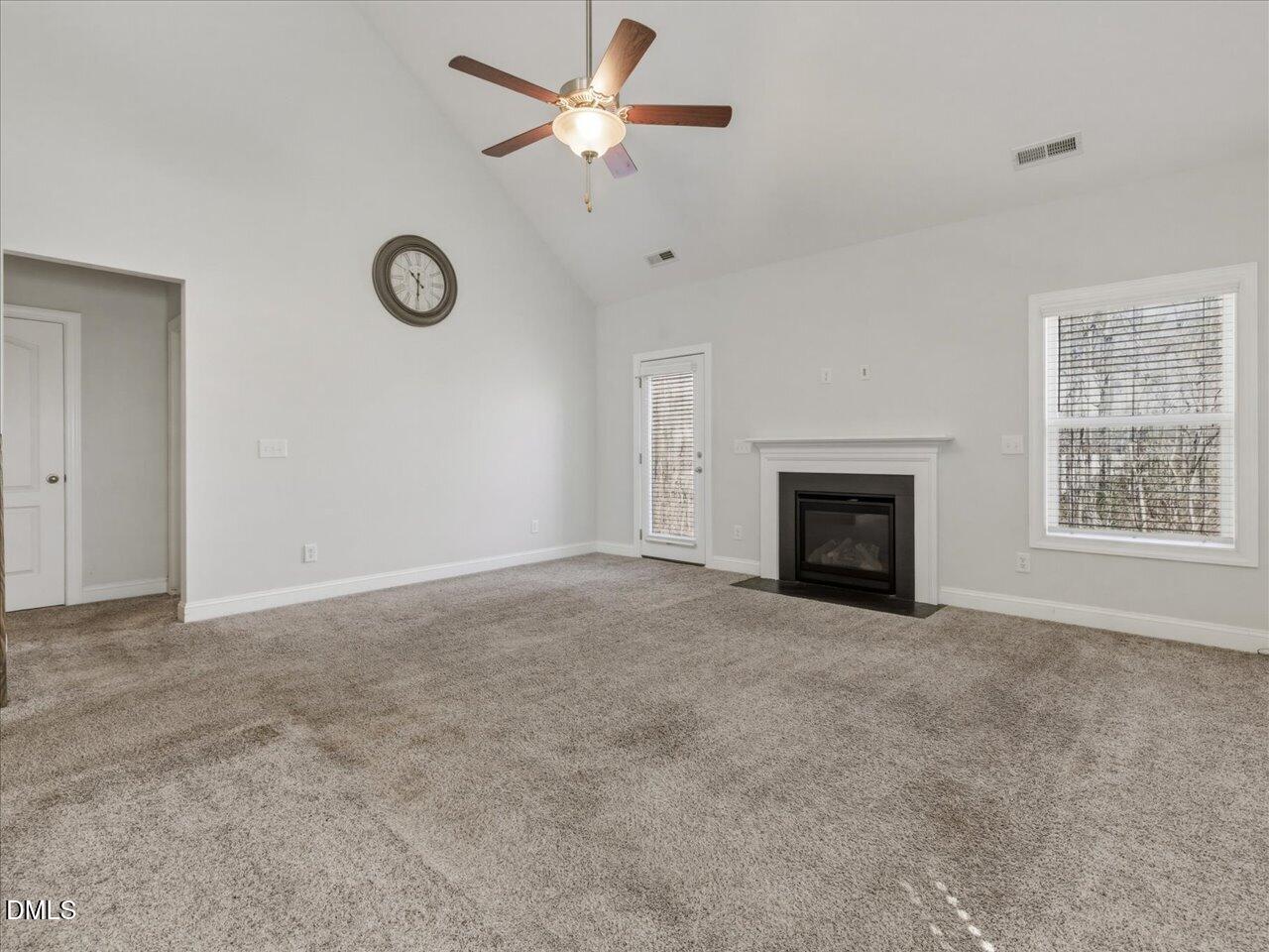 60 Pepper Lane Garner, NC 27529 - Photo 26 of 70 an empty room with a fireplace and a window