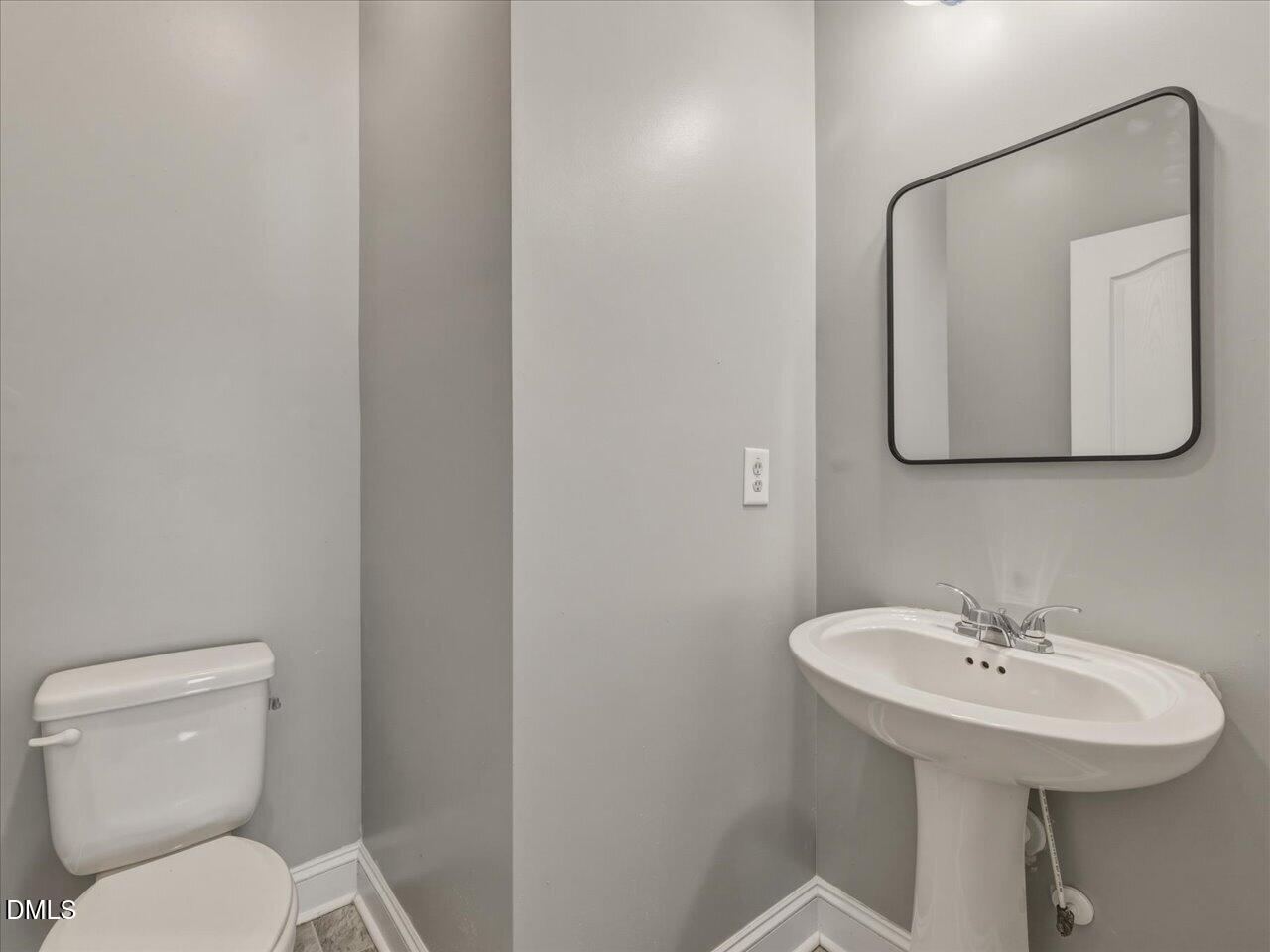 60 Pepper Lane Garner, NC 27529 - Photo 30 of 70 a bathroom with a toilet sink and mirror