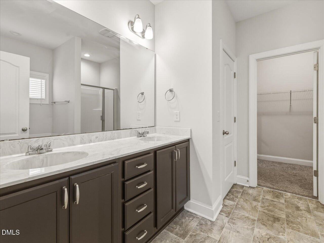 60 Pepper Lane Garner, NC 27529 - Photo 34 of 70 a bathroom with a granite countertop sink a mirror and a shower