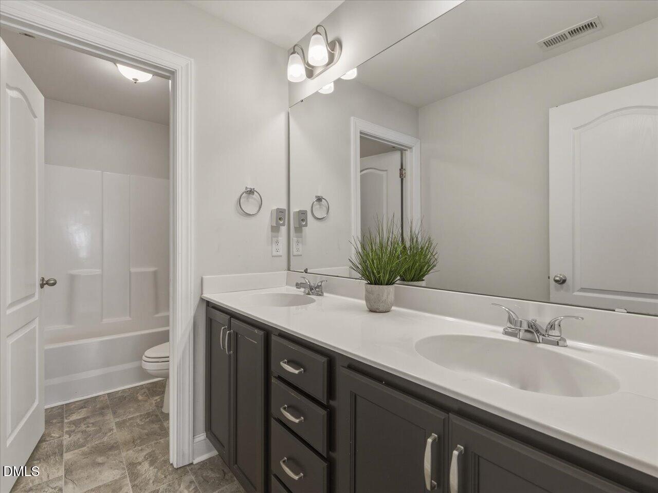 60 Pepper Lane Garner, NC 27529 - Photo 51 of 70 a bathroom with a sink and a mirror