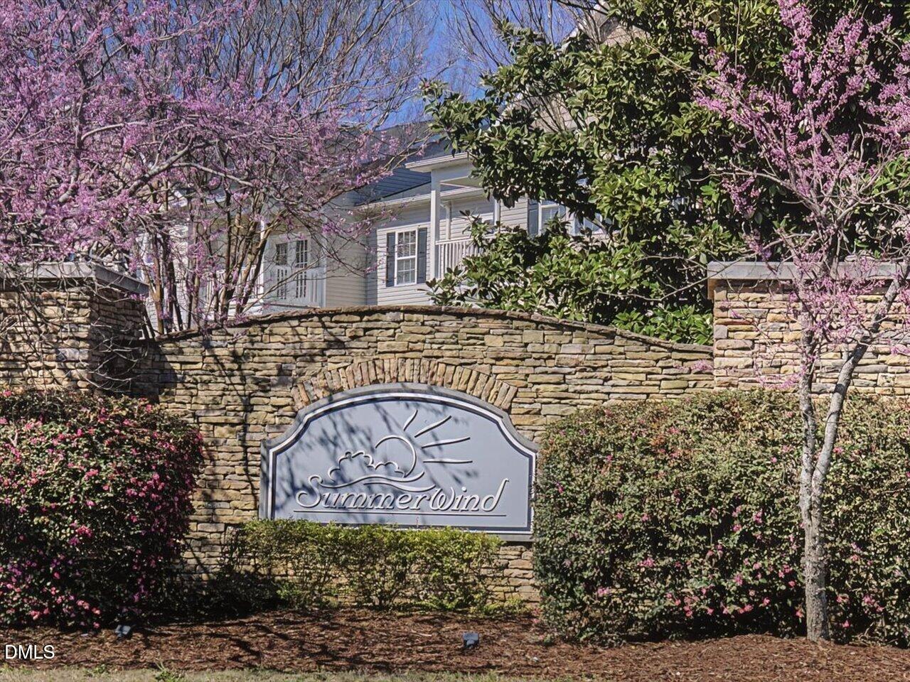 60 Pepper Lane Garner, NC 27529 - Photo 62 of 70 a sign that is sitting in front of a brick house with large windows