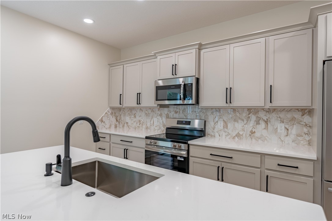 7876 Burkey Road Northwest North Canton, OH 44720 - Photo 10 of 40 Stainless appliances and large island sink.
