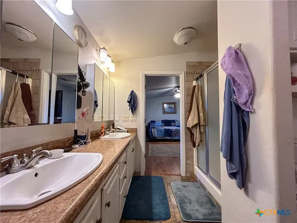 a bathroom with a sink double vanity and a mirror