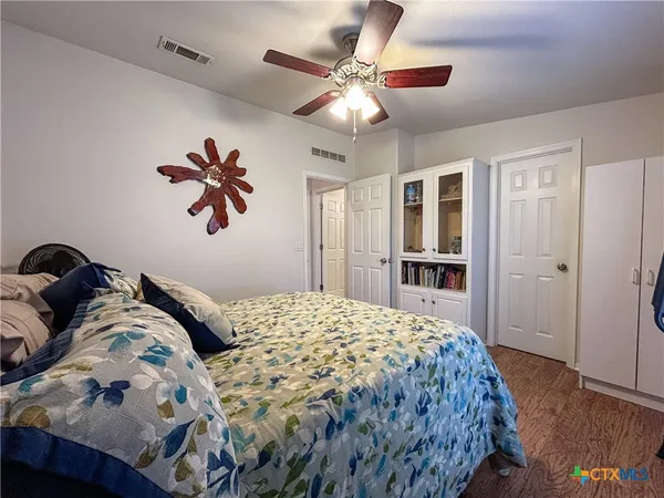 a bedroom with a large bed and a chandelier